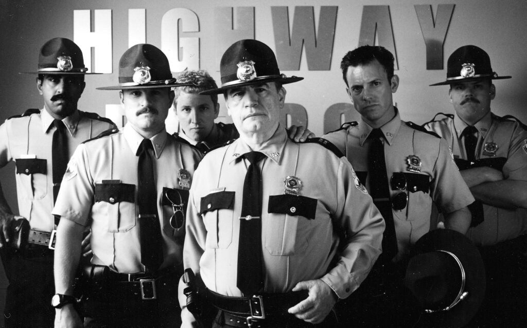 State highway troopers standing against a wall