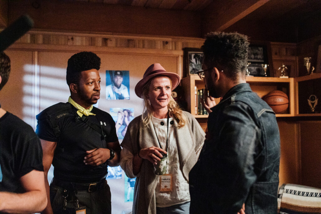 Woman with Charlotte name tag in discussion with two men