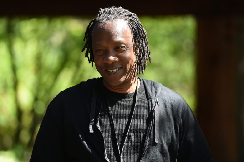 Man in dreadlocks smiles