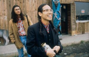 Two Native Americans standing in front of a building