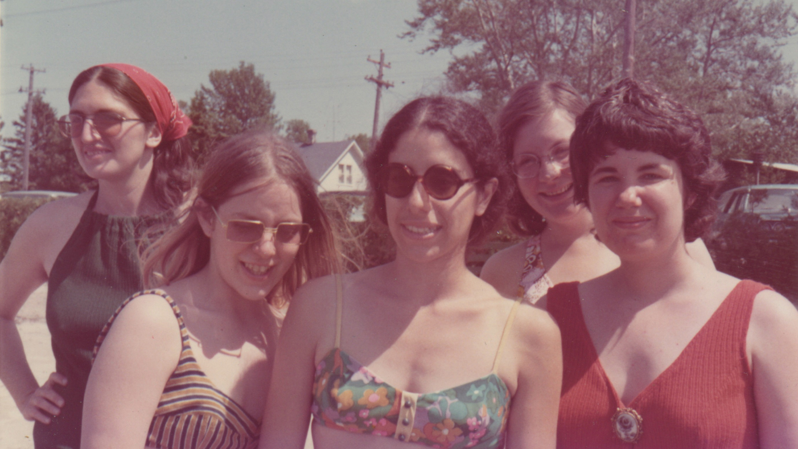 A vintage shot of a group of women in the sixties in tank tops smiling