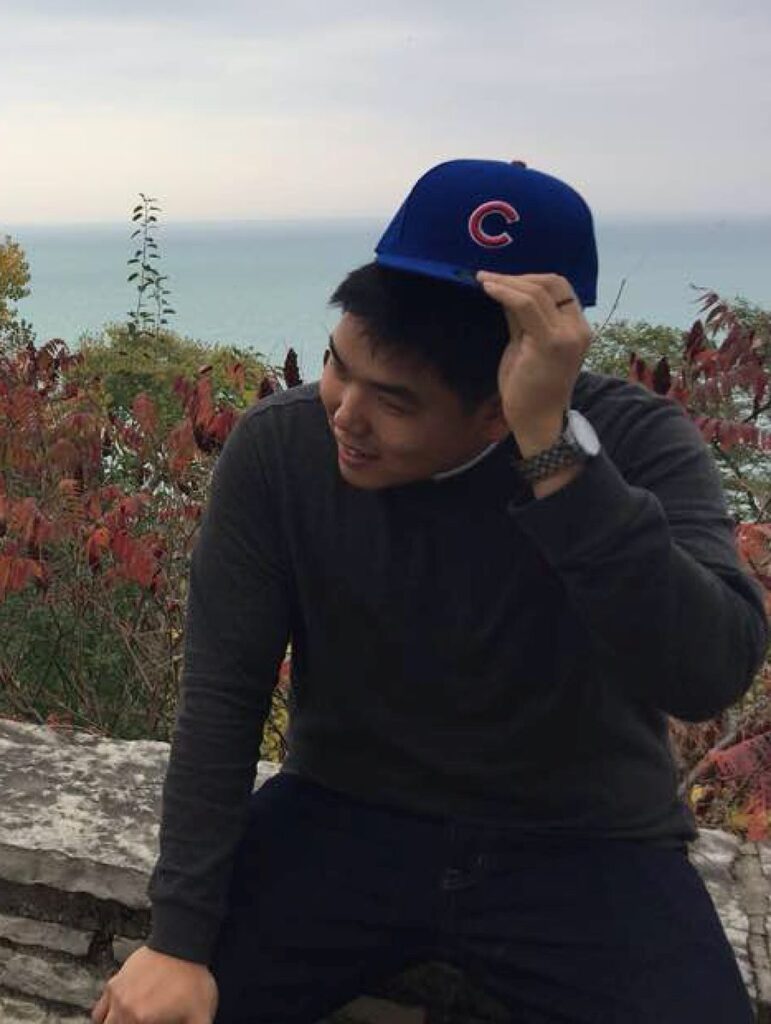 Asian man with Chicago Cubs cap