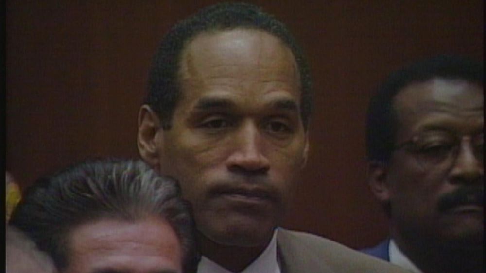 Black man in suit with grim expression
