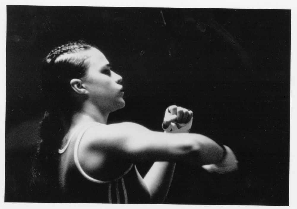 Young black woman with taped-up hands in boxing sparring position