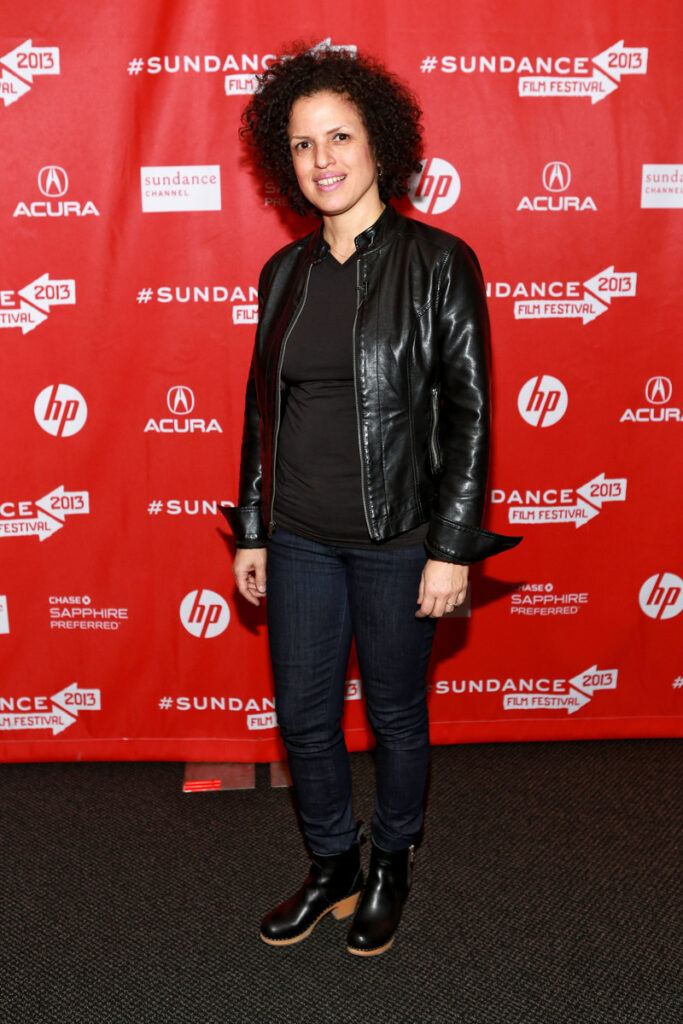 woman smiling at press line for movie premiere