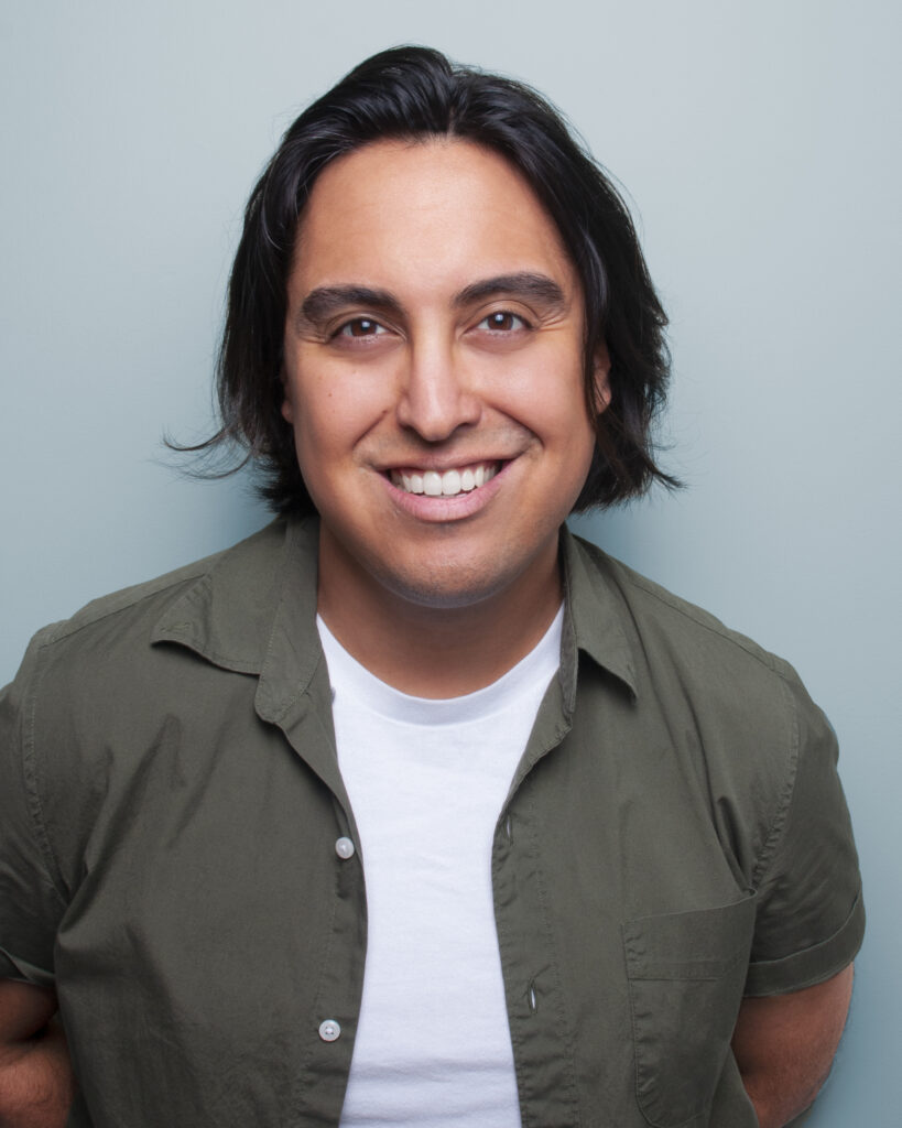 Headshot of a Native man smiling