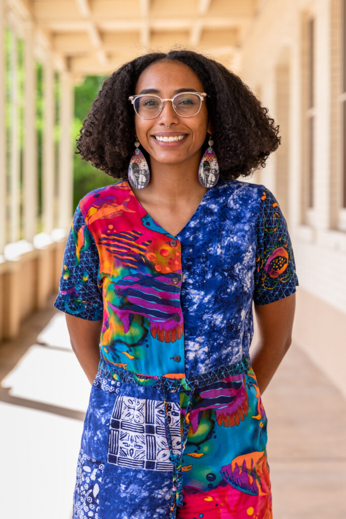 Indigenous woman smiling and posing at camera for headshot