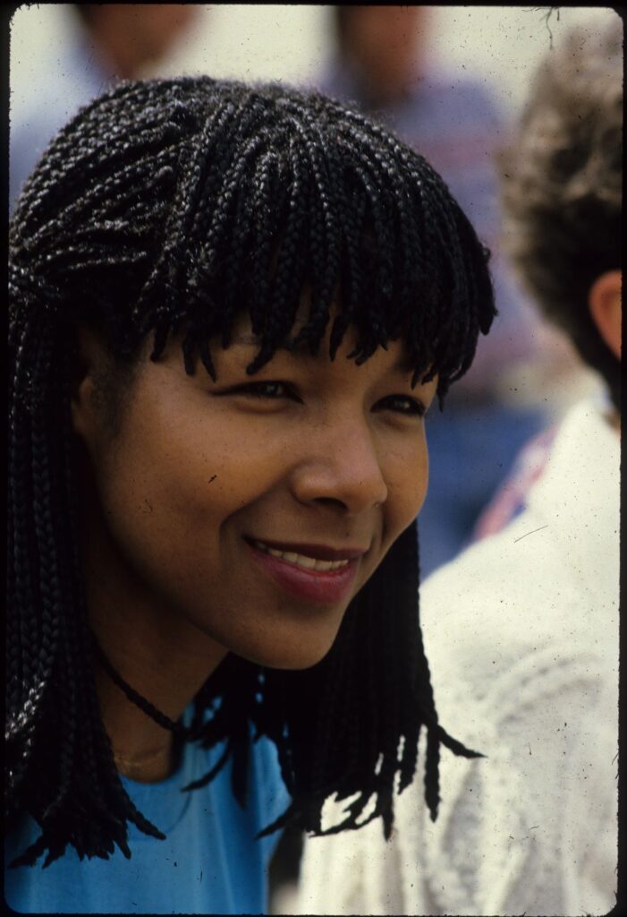 Head and shoulders shot of young Black woman with dreadlocks