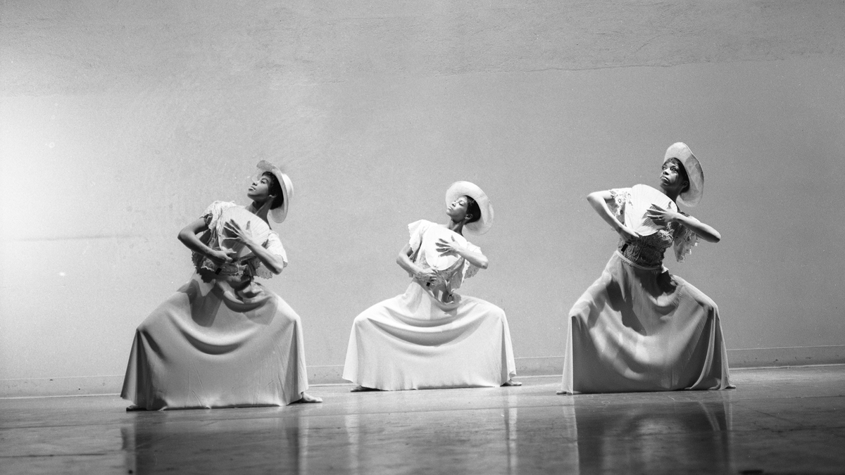 three black women dancing in black and white still