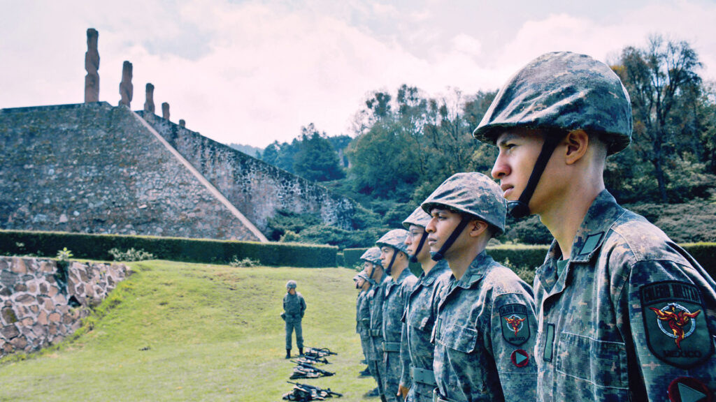 A line of young soldiers are staring straight ahead