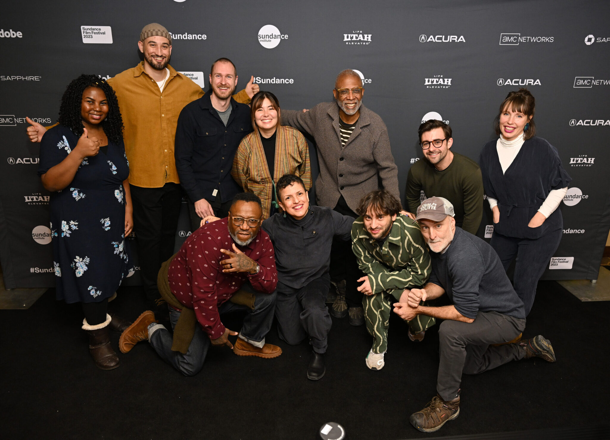 large group of people kneeling and standing and posing for a photo