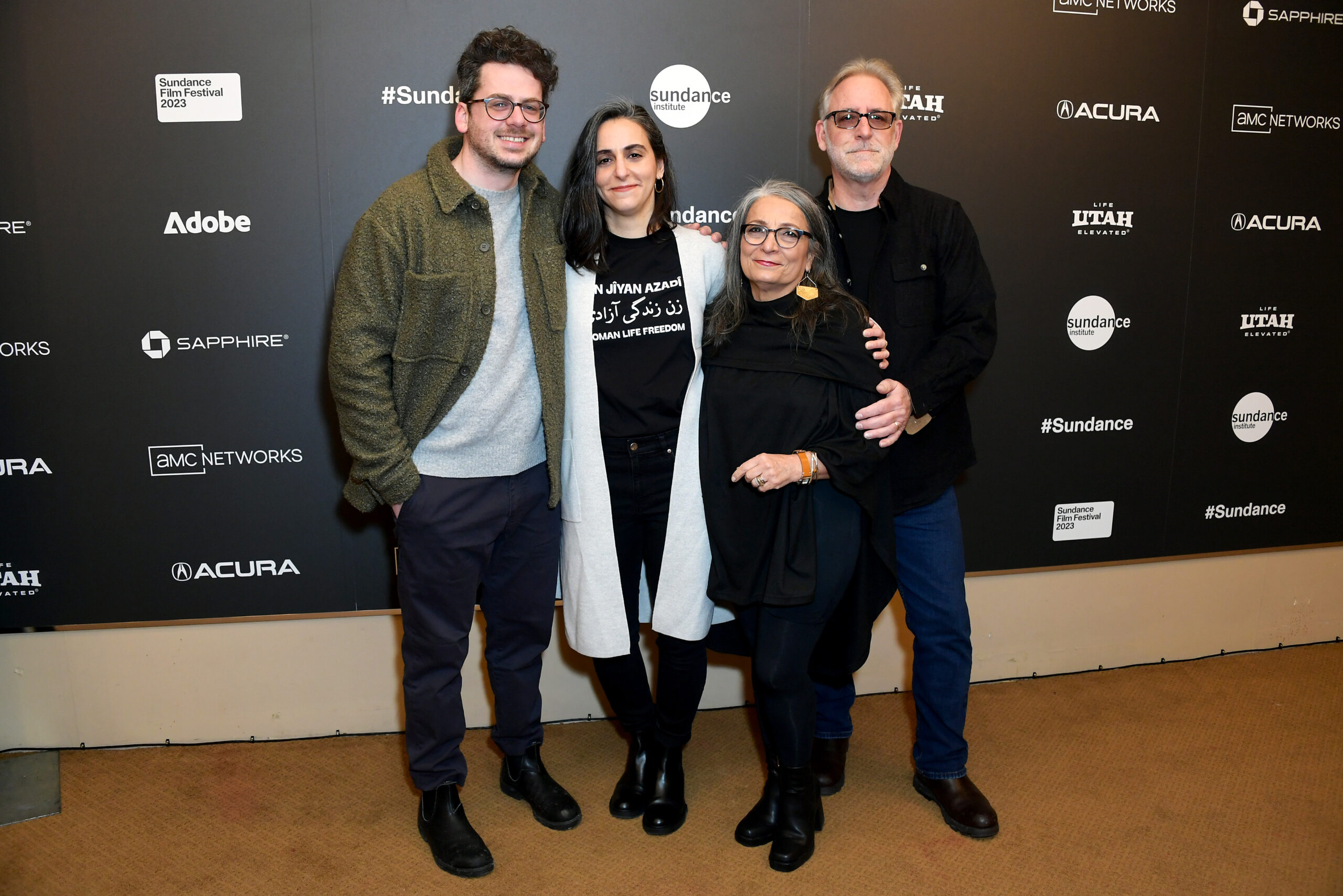 stand in front of a step and repeat at the 2023 Sundance Film Festival.