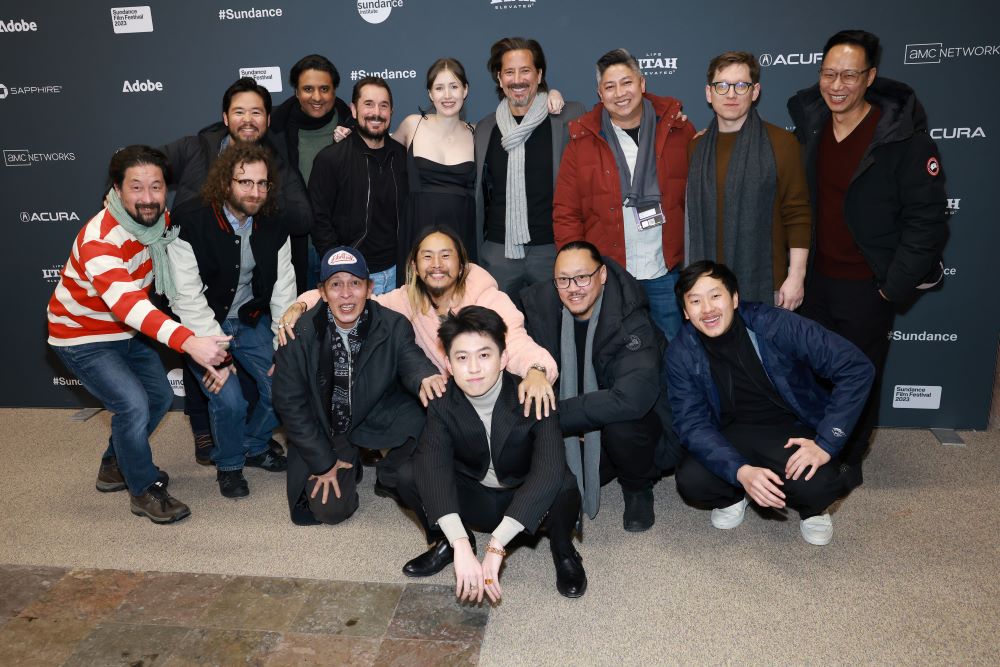 The cast and crew of Jamojaya all stand in front of a step and repeat at the 2023 Sundance Film Festival in Park City, Utah.