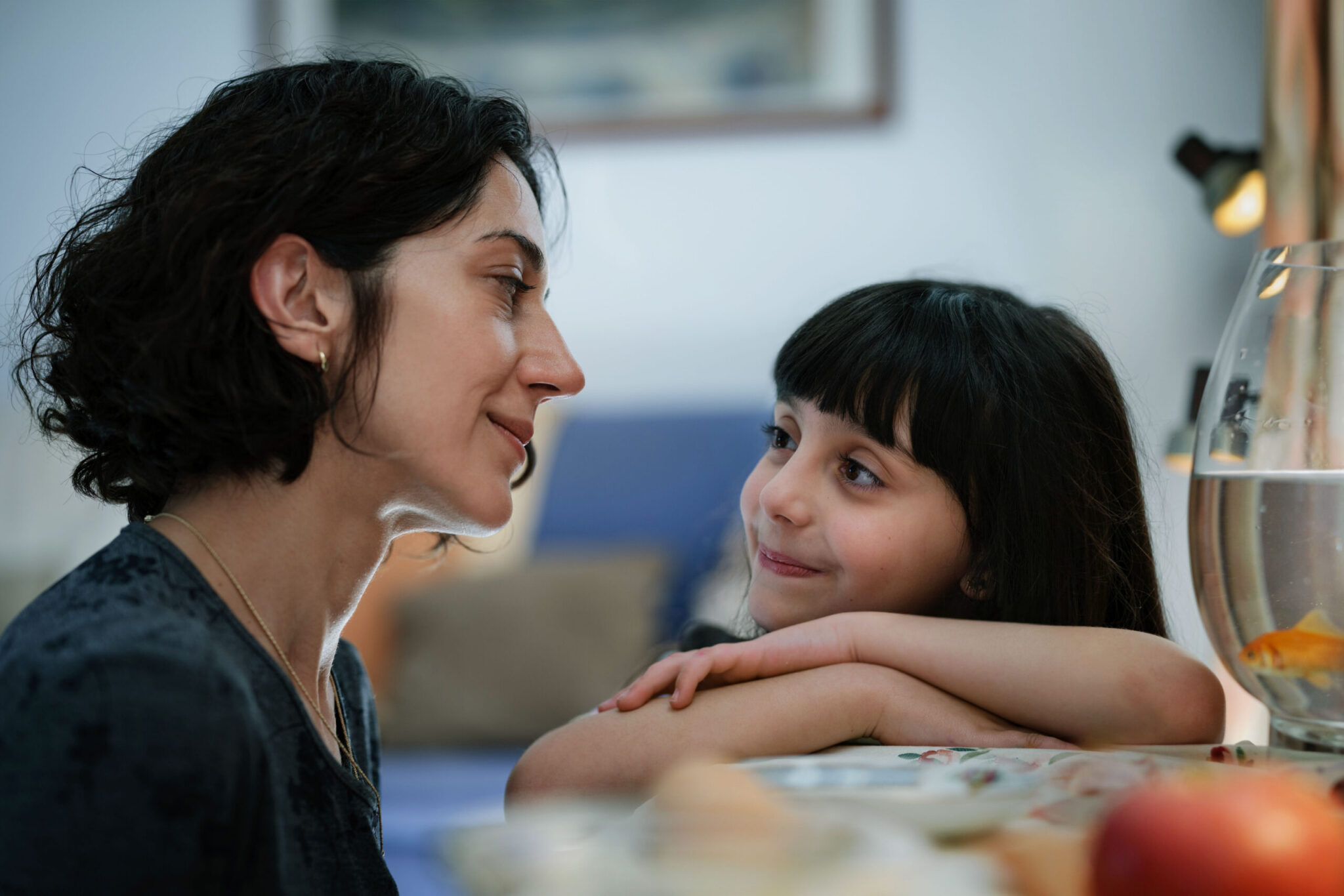 A close up of a mother looking into the eyes of her daughter