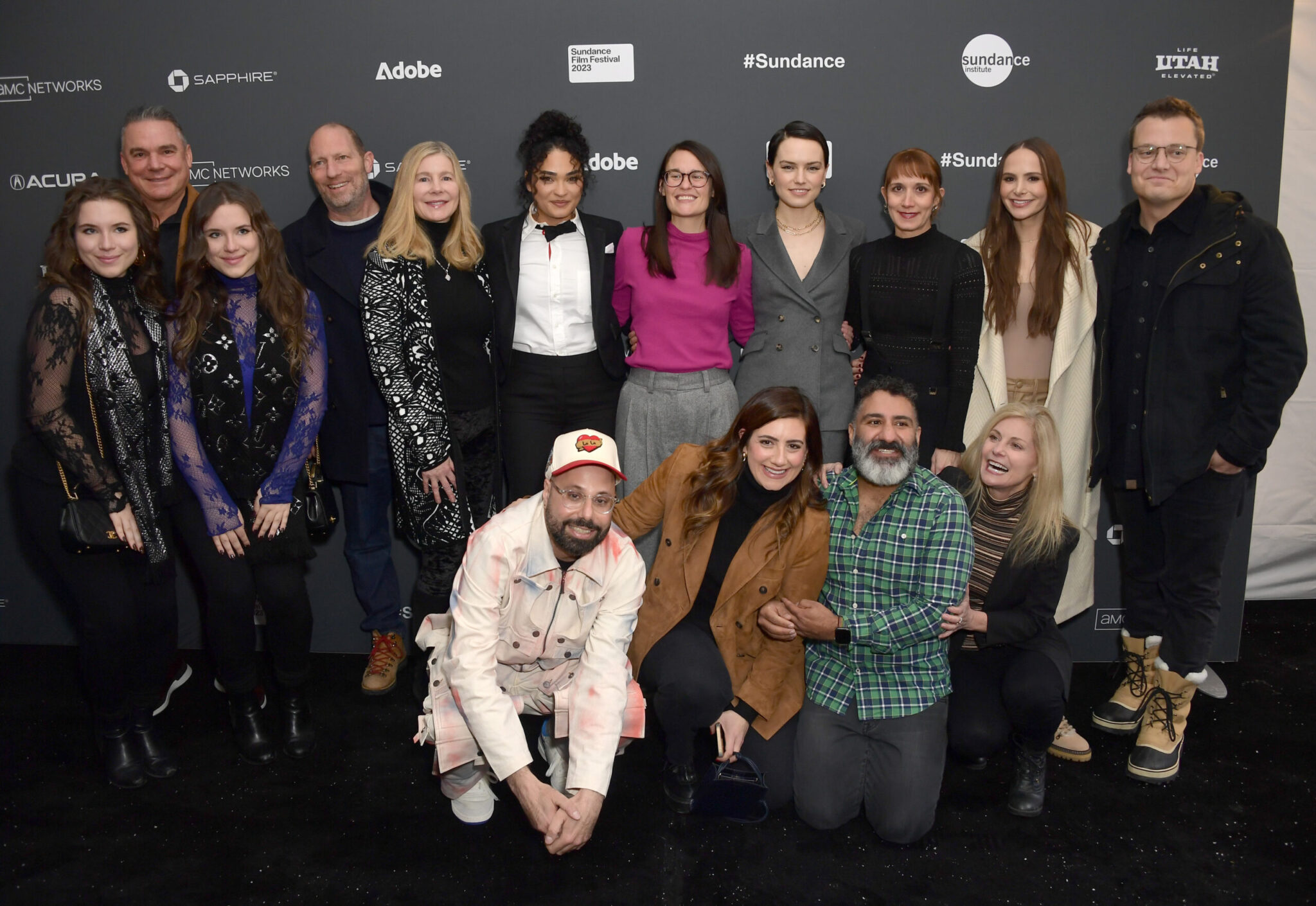 the cast and crew of Sometimes I Think About Dying stands together in front of a step -and-repeat at the 2023 Sundance Film Festival