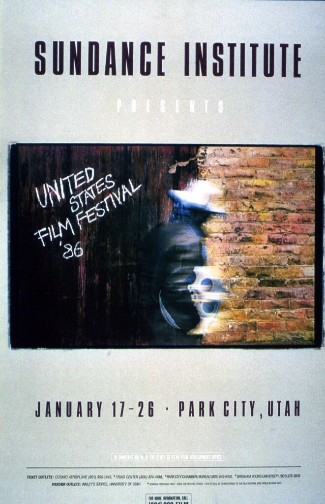 Blurred image of a person in a white hat carrying a large reel of film against a background of wood and brick. Printed: "Sundance Institute Presents United States Film Festival '86 January 17-26 Park City, Utah"