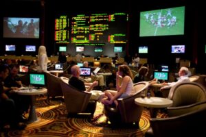 People in a busy room of televisions and monitors