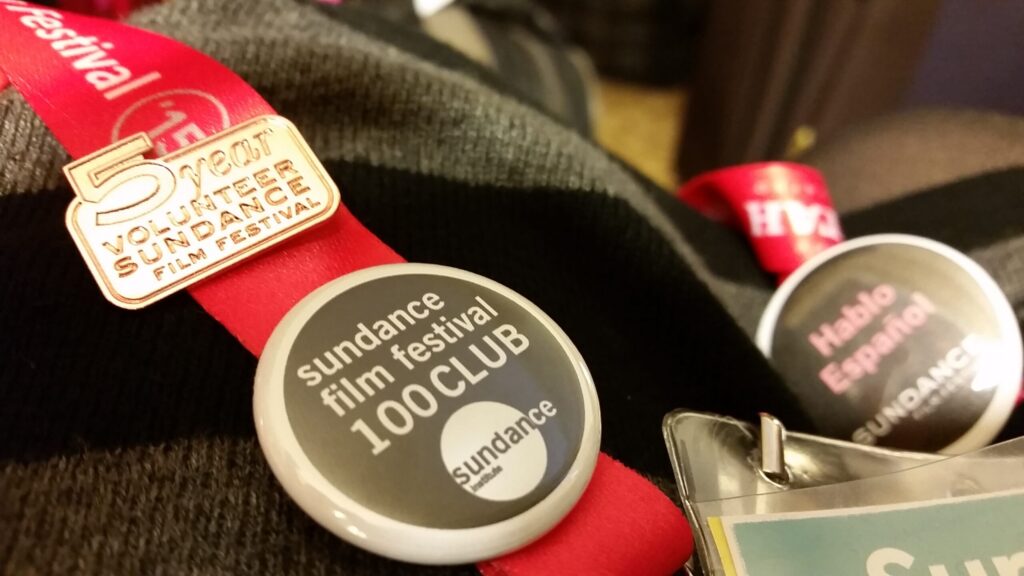 Close up image of a lanyard with buttons on it about sundance volunteers
