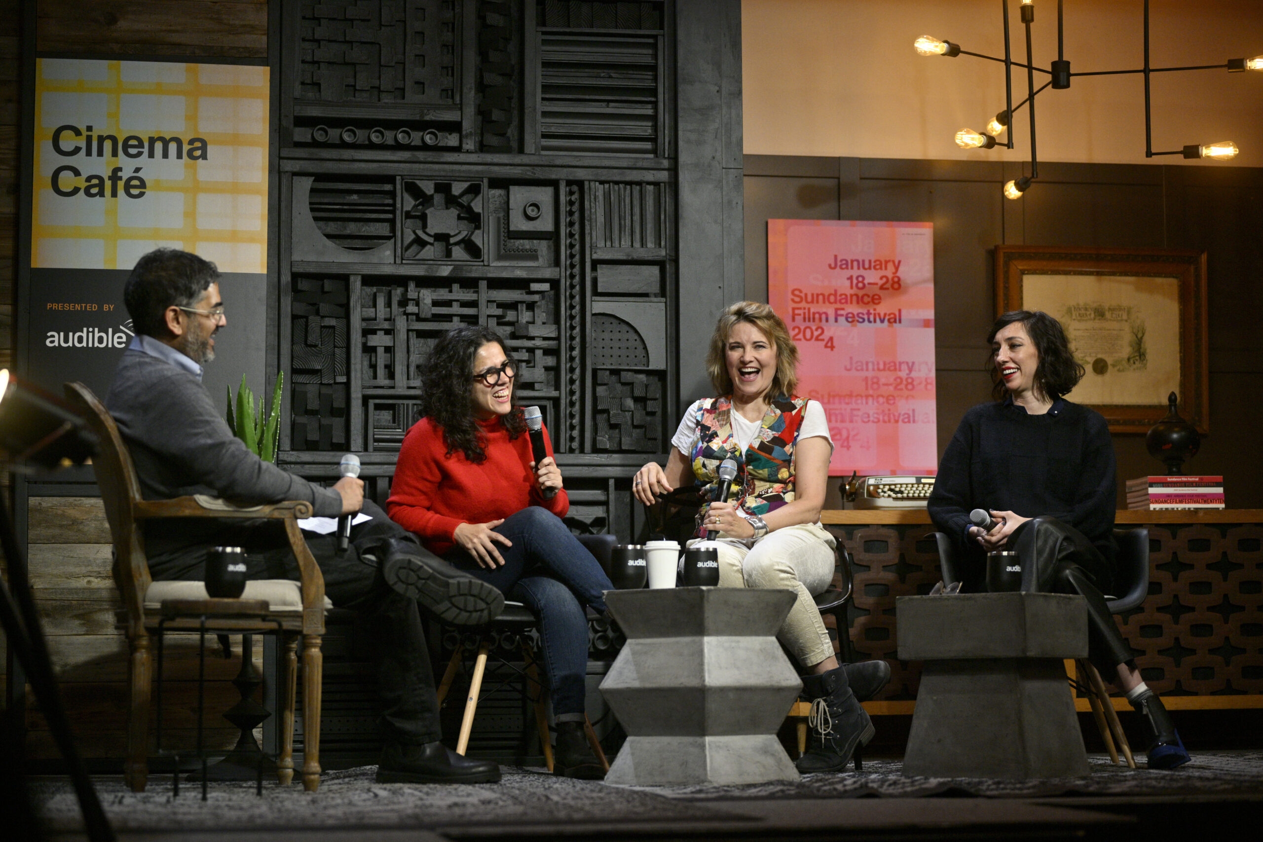 Sudeep Sharma, Carla Gutiérrez, Lucy Lawless, and Lana Wilson sit on stage at the Cinema Café.