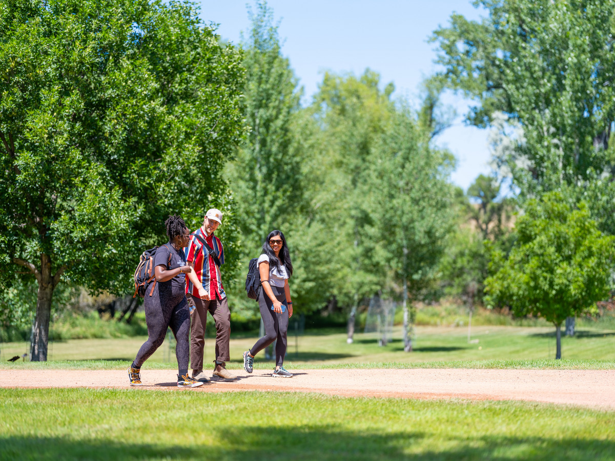 'Basketball Heaven' fellow Crystal Isaac, 'Untitled Science Project' fellow Elijah Stevens, and 'Becoming Us' fellow Loi Ameera Almeron take a walk together during the 2025 Documentary Producers Lab. Photo by Lance Roth