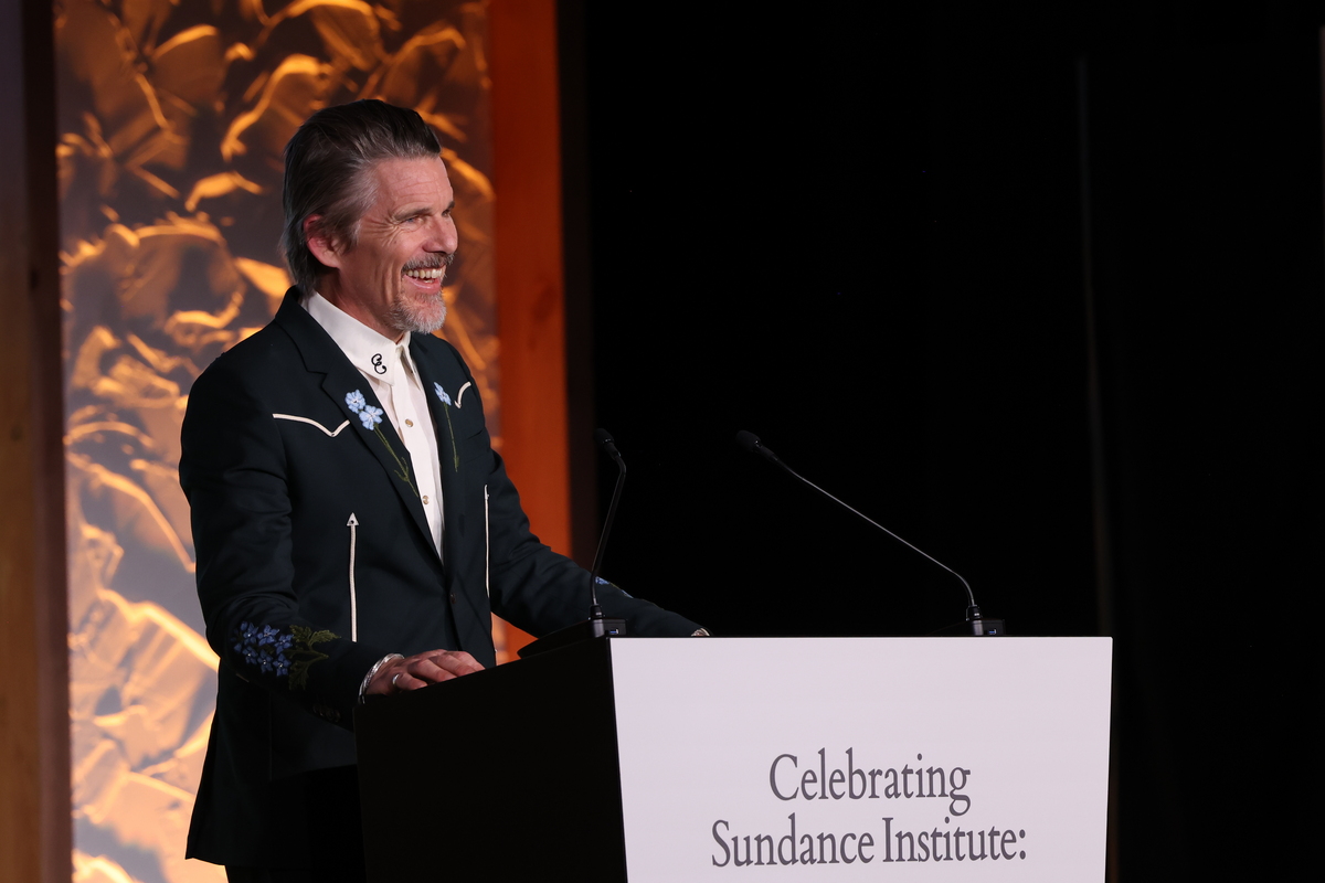 Ethan Hawke smiles on stage at Celebrating Sundance Institute: A Tribute to Founder Robert Redford. Photographer: Stephanie Dunn