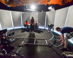 Crew members prepare the next shot while director Francisca Alegri speaks with actors on set for 'The Cow that Sang a Song About the Future.' Photographer: Jonathan Hickerson