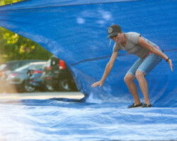 Guests test out their surfing skills at a free community screening of 'Riding Giants' at City Park. Photographer: Jonathan Hickerson