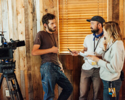 Director of photography Eli Born, director Andrew Bruntel, and Alexis Vail on the set of 'Wolf in White Van.' Photographer: Jen Fairchild
