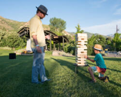 Guests play large-scale lawn games as they eagerly await the screening of 'Believer' at the Red Butte Amphitheatre. Photographer: Jonathan Hickerson