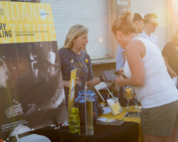 A volunteer helps guests learn about membership opportunities with the Sundance Institute. Photographer: Jonathan Hickerson