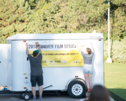 Staff ensures everything is in order before a screening of 'Believer' at the Red Butte Garden Amphitheatre. Photographer: Jonathan Hickerson