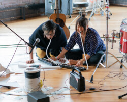 'Clairvoyance' fellows Mei Ann Teo and Diana Oh test out the melodica at the 2018 Theatre Lab at Mass MoCA. Photographer: Kaelan Burkett