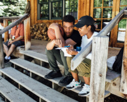 Actor Ismael Cruz Cordova and directing fellow A.V. Rockwell on the set of 'A Thousand and One Nights.' Photographer: Jen Fairchild