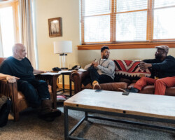 Screenwriting fellows Aristotle Torres and Bonsu Thompson (Center and Right) discuss their project 'Story Ave' with creative advisor Walter Mosley. Photographer: Jen Fairchild