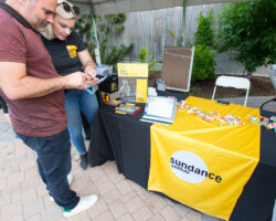 A staff member helps guests sign up for a Sundance Institute Membership. Photographer: Lauren Wester
