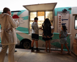 Guests enjoy the Waffle Love food truck at a free community screening of 'RBG.' Photographer: Dan Campbell