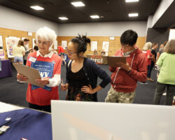 A member from the League of Women Voters helps guests register to vote at a free community screening of 'RBG.' Photographer: Dan Campbell