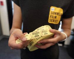 A volunteer distributes raffle tickets to guests at a free screening of 'Top End Wedding'. Photographer: Dan Campbell