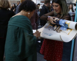 'The Farewell' actor Diana Lin signs a poster on the press line at the Ace Hotel. Photographer: Aaron Farley