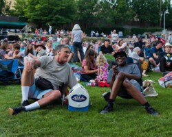 Guests share a laugh at a community screening of 'Summer of Soul' at Red Butte Garden Amphitheater. Photographer: Jonathan Hickerson