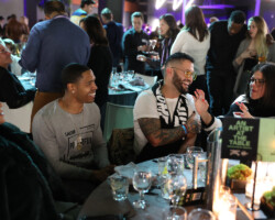Charm City Kings filmmaker Angel Manuel Soto enjoys dinner with guests from the Will and Jada Smith Family Foundation.