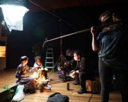 On the set of Hasan Hadi's 'The President's Cake.' Photographer: Larin Sullivan A crew member holds a boom mic over to actors