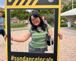 Moviegoer strikes a pose before the 2024 Local Lens summer screening of 'Skywalkers: A Love Story.' Photographer: Kentrell Charles