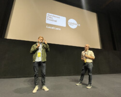 Actor Tommy Dewey, alongside Sundance Film Festival senior programmer Basil Tsiokos, answers questions from the audience during the 2024 Local Lens summer screening of 'Your Monster.' Photographer: Brady Christianson