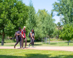 'Basketball Heaven' fellow Crystal Isaac, 'Untitled Science Project' fellow Elijah Stevens, and 'Becoming Us' fellow Loi Ameera Almeron take a walk together during the 2025 Documentary Producers Lab. Photo by Lance Roth