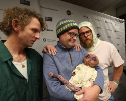 THUNDERLIPS (aka Jordan Mark Windsor and Sean Wallace) watch over Festival programmer Adam Montgomery as he cradles the 'Mum, I'm Alien Pregnant' baby on the press line. Photographer: Lauren Hartmann