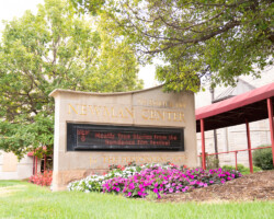 A sign outside of the Newman Center welcomes attendees to the Mostly True Stories From the Sundance Film Festival event in Denver, Colorado. Photographer: Devon Wycoff