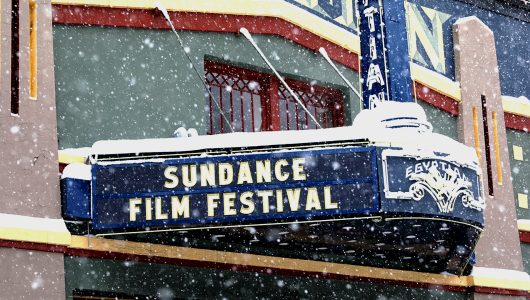 Snow falls on marquee at the Egyptian Theatre that reads "Sundance Film Festival"