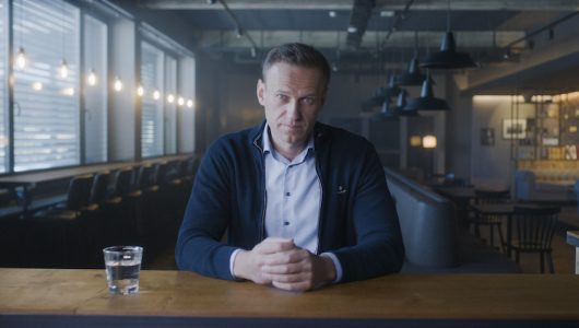 Photo of Alexei Navalny sitting at a table with his hands folded